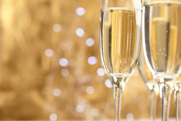 champagne glasses against gold background