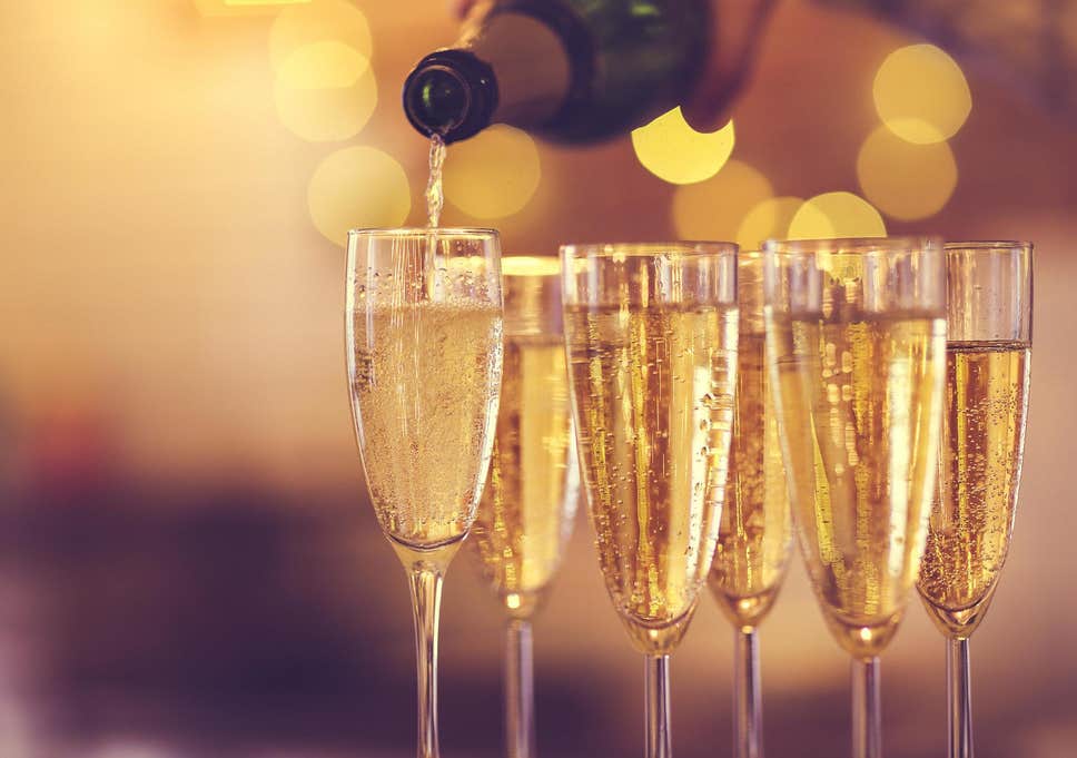 Champagne being poured in to glasses for festive drinks at Christmas