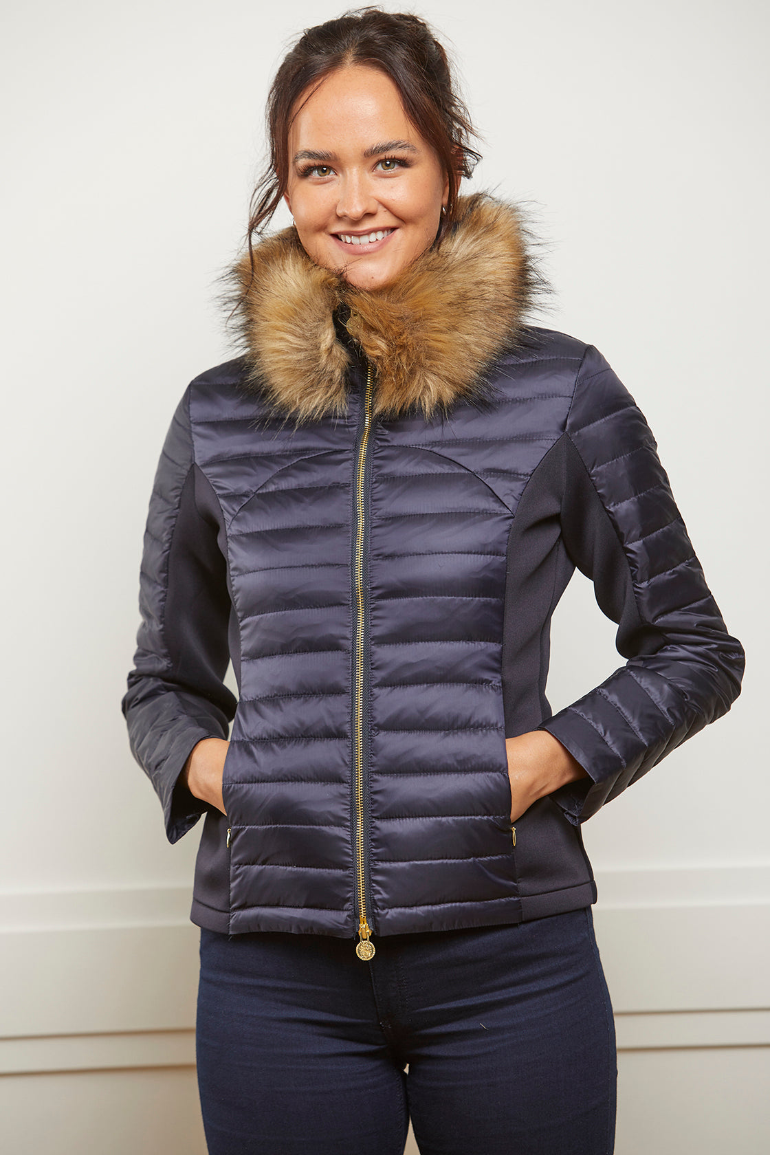 Navy down puffer jacket with gold zip and stretch side panels and detachable faux fur collar.