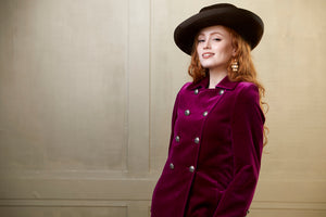 Women's full length coat in deep pink velvet. The double breasted coat has silver military style buttons