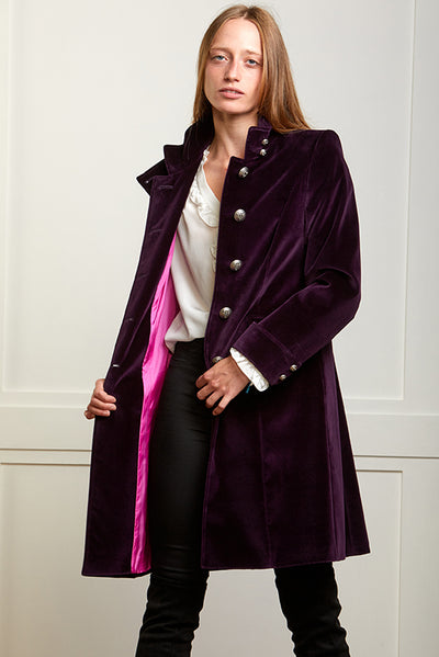 Womens navy velvet boho coat with high collar, silver buttons and elegant tailoring. The coat is open showing the pink lining.