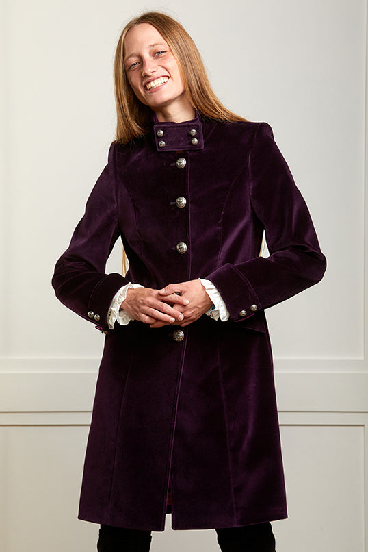 Tailored purple velvet coat with silver military style buttons and classic tailoring