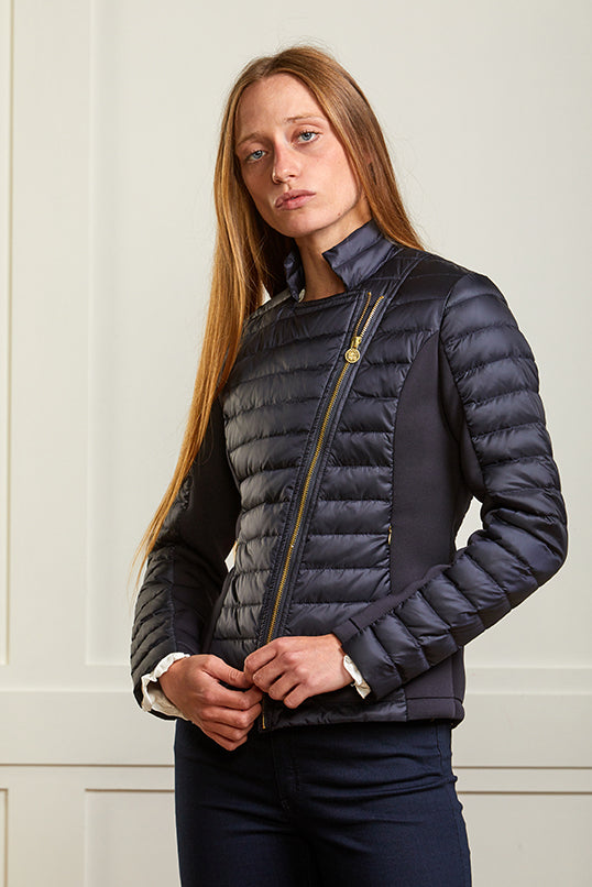 Women's navy biker jacket in a puffer style with stretch side panels.