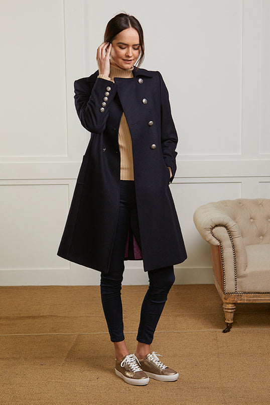Women's navy wool coat in a double breasted style with silver military style buttons